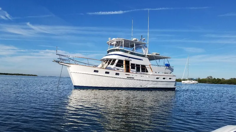 The Image of 1987 Tayana 45 Expedition Trawler on calm water under clear blue sky. - 0