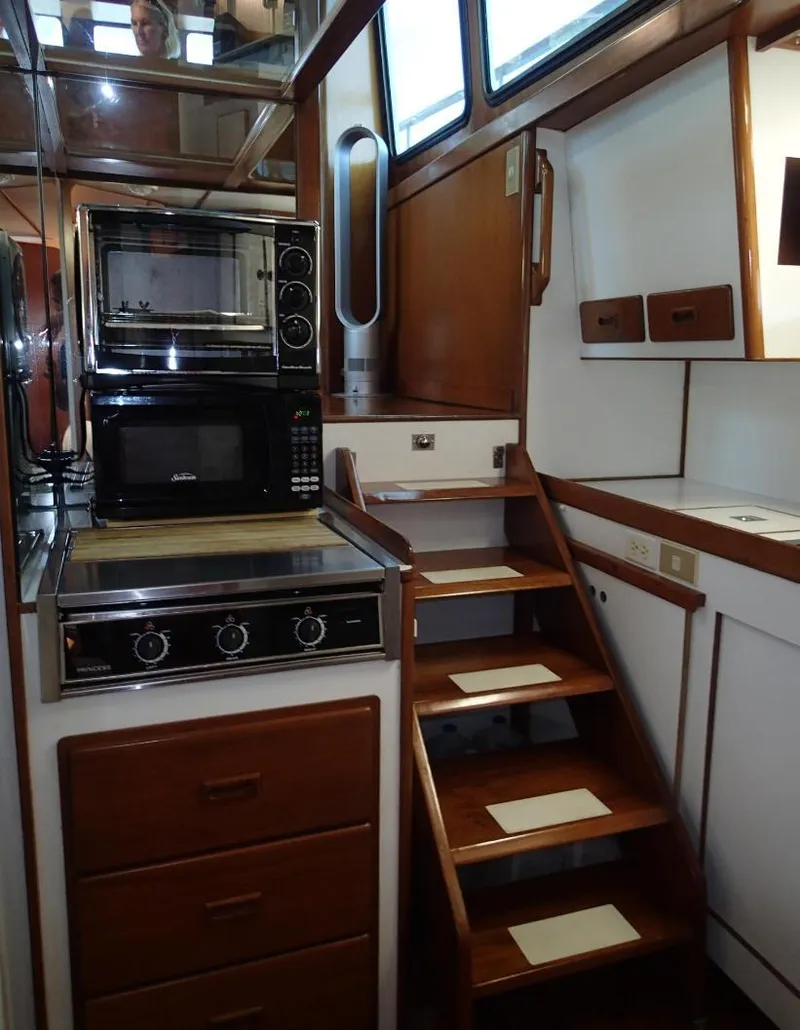 Slide: The Image of Interior of 1987 Tayana 45 Expedition Trawler with kitchen and wooden stairs. - 15