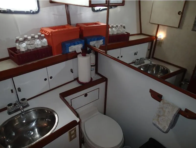 Slide: The Image of 1987 Tayana 45 Expedition Trawler bathroom with sink, toilet, and storage. - 20