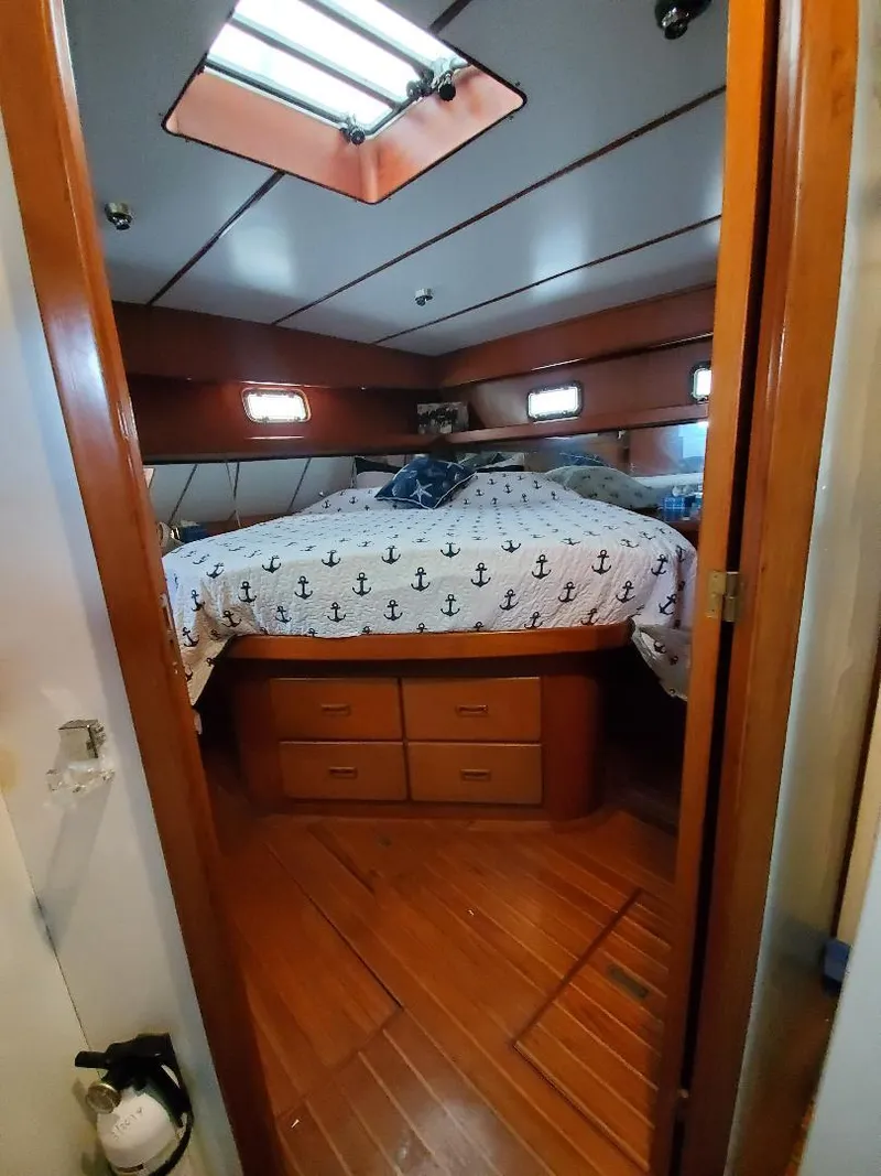 Slide: The Image of Cozy bedroom in 1987 Tayana 45 Expedition Trawler with anchor-themed bedding. - 22
