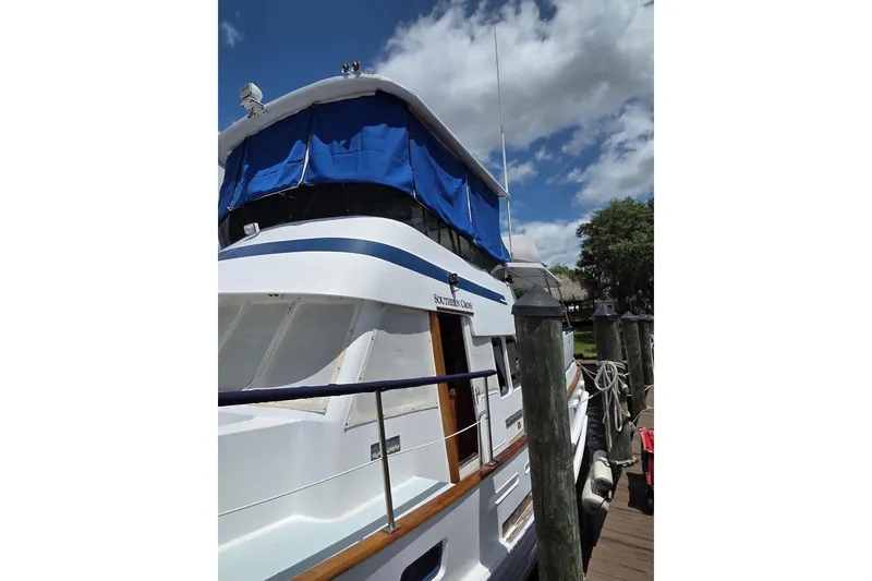 Slide: The Image of 1987 Tayana 45 Expedition Trawler docked under a blue sky. - 25