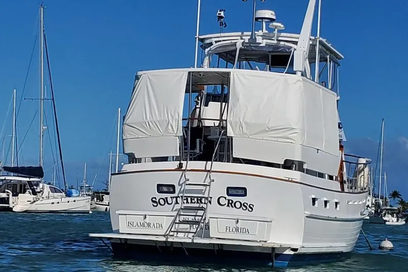 Slide: The Image of Tayana 45 Expedition Trawler 1987 anchored in marina, rear view with covered deck. - 27