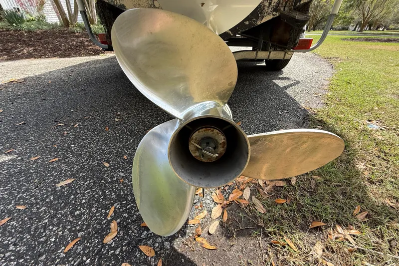 Slide: The Image of Propeller of a 1997 Regulator 23 boat on a trailer, parked on a driveway. - 10