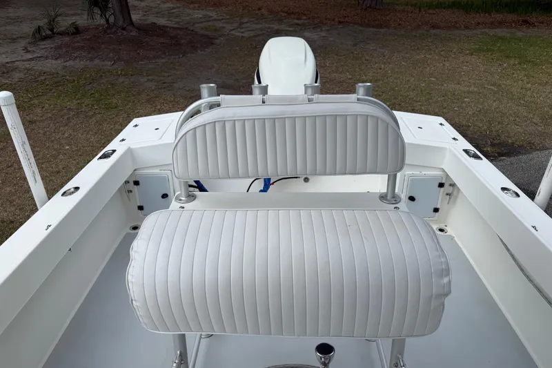 Slide: The Image of 1997 Regulator 23 boat interior with white cushioned seating and clean deck. - 15
