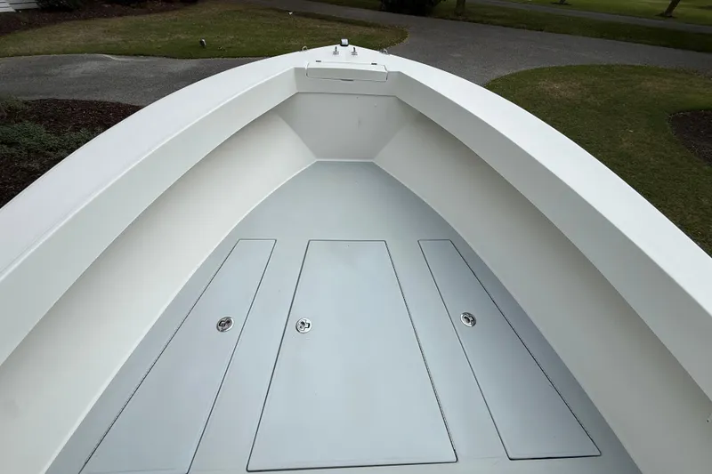 Slide: The Image of 1997 Regulator 23 boat interior, showcasing spacious deck and storage compartments. - 18