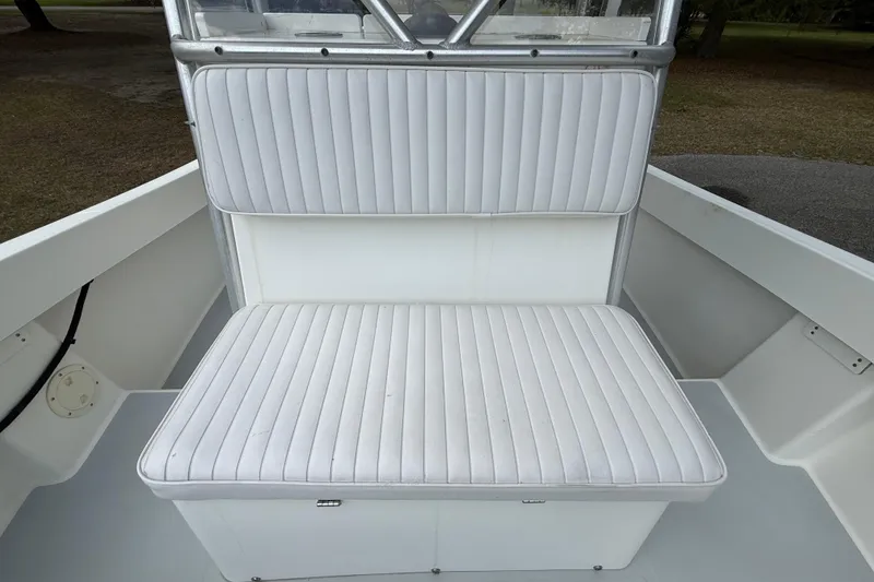 Slide: The Image of White cushioned seating on a 1997 Regulator 23 boat, showcasing clean design. - 19