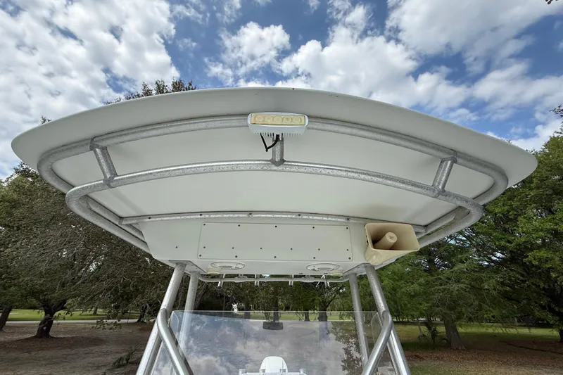 Slide: The Image of 1997 Regulator 23 boat T-top with light and speaker, under a partly cloudy sky. - 20