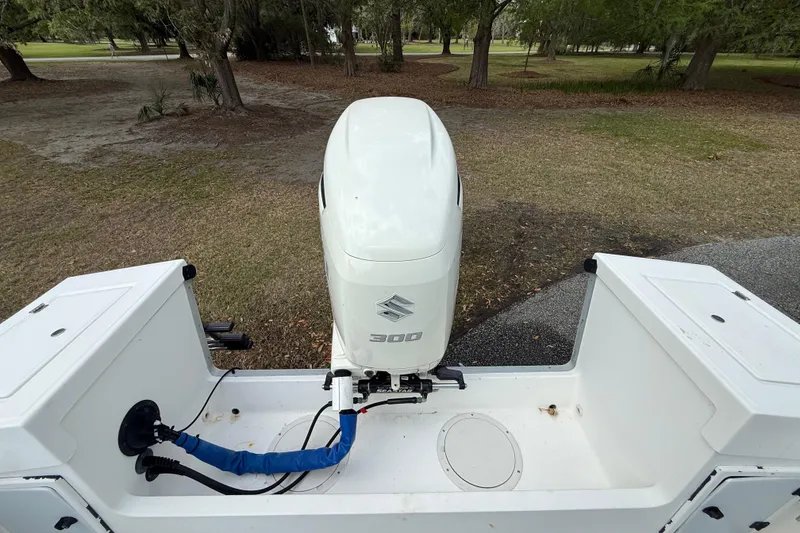 Slide: The Image of Outboard motor on a 1997 Regulator 23 boat, parked on grass. - 22