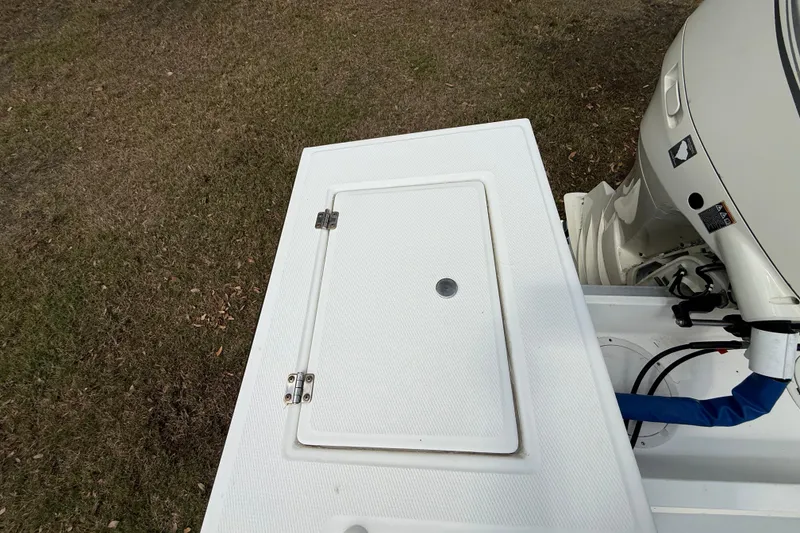 Slide: The Image of 1997 Regulator 23 boat deck with hatch and outboard motor. - 24