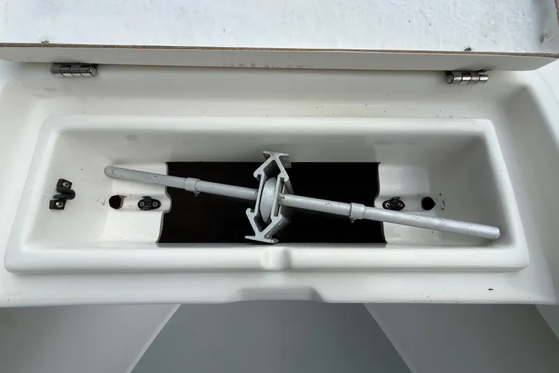 Slide: The Image of Storage compartment of a 1997 Regulator 23 boat with a metal rod inside. - 26