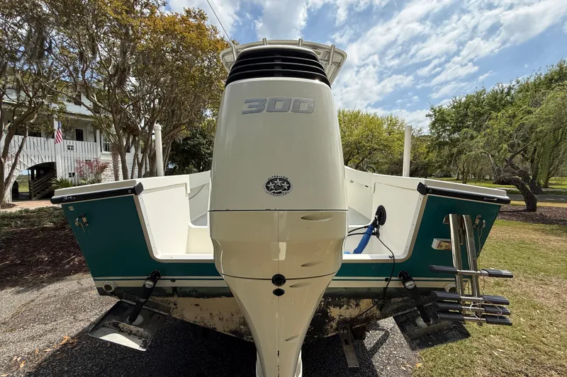 Slide: The Image of 1997 Regulator 23 boat with powerful 300 horsepower engine, parked outdoors. - 7