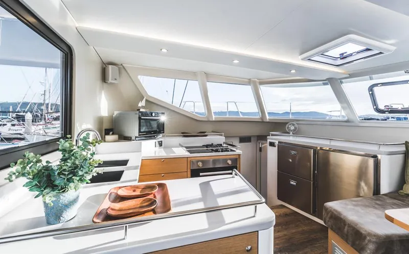 Slide: The Image of Modern yacht kitchen interior with sleek design, stainless appliances, and panoramic windows. Vision 444, 2026 model. - 15