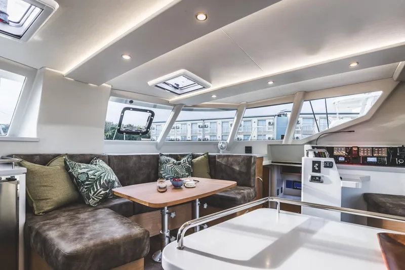 Slide: The Image of Luxurious interior of Vision 444 yacht, 2026 model, featuring modern seating and navigation controls. - 18