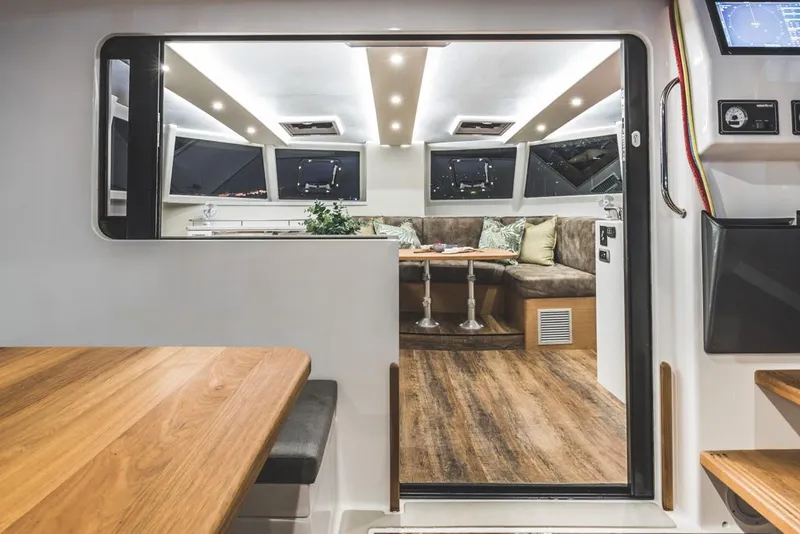 Slide: The Image of Modern Vision 444 yacht interior, featuring sleek design, wood flooring, and comfortable seating, 2026 model. - 23