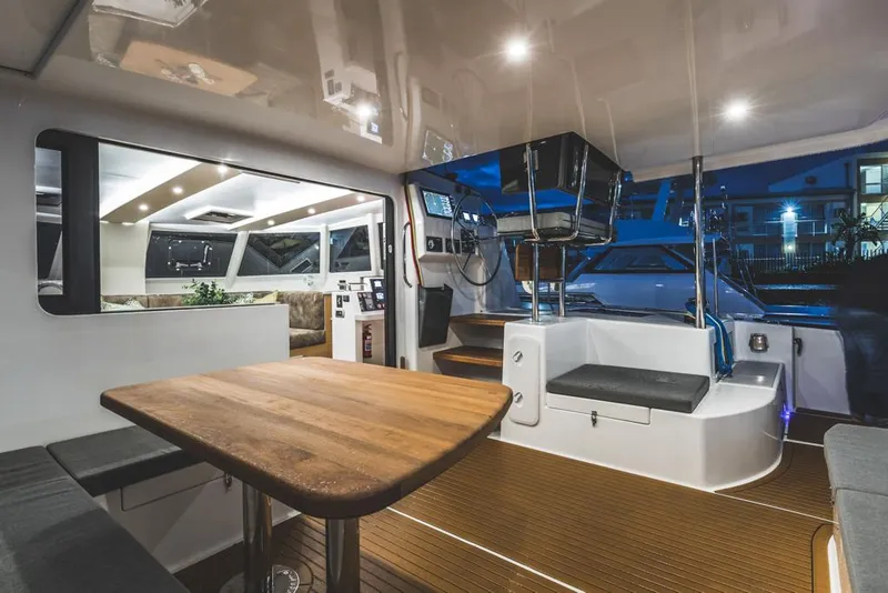 Slide: The Image of Modern Vision 444 yacht interior, featuring sleek design, wooden table, and ambient lighting, 2026 model. - 24