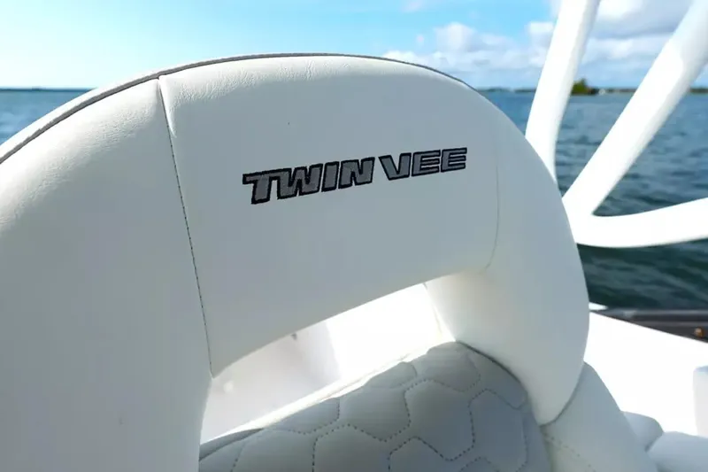 Slide: The Image of 2026 Twin Vee 240 GFX DC boat seat with logo, ocean background. - 13