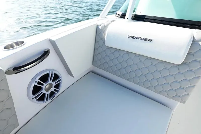 Slide: The Image of 2026 Twin Vee 240 GFX DC boat interior with hexagonal upholstery and speaker detail. - 17