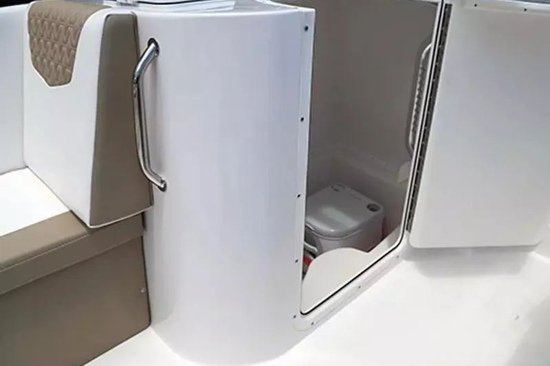 Slide: The Image of Interior view of 2026 Twin Vee 240 GFX DC boat with compact toilet compartment. - 20