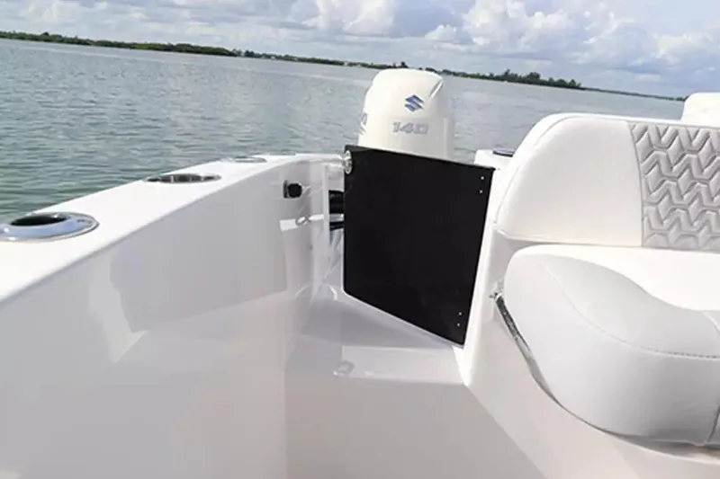 Slide: The Image of 2026 Twin Vee 240 GFX DC boat interior with white seating and scenic water view. - 22