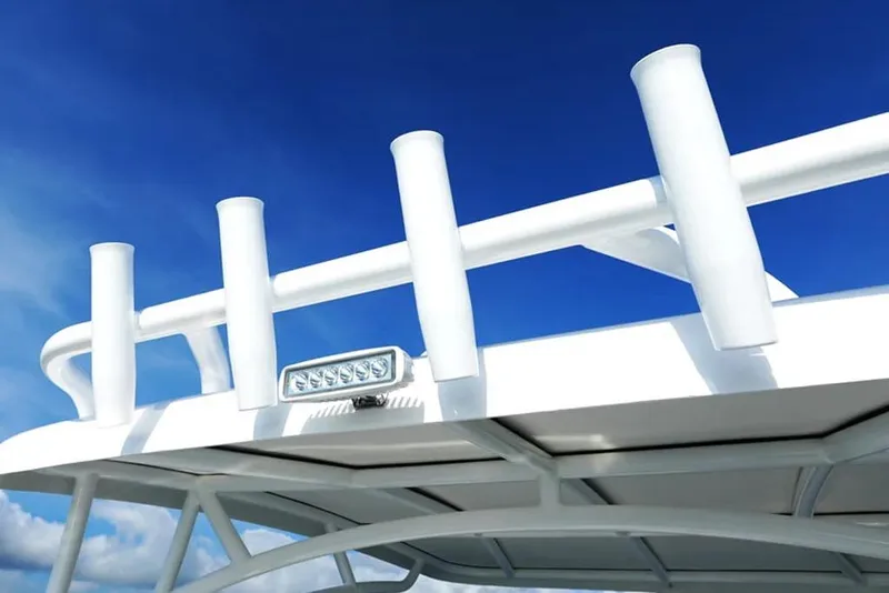 Slide: The Image of 2026 Twin Vee 240 GFX DC boat roof with rod holders against blue sky. - 3