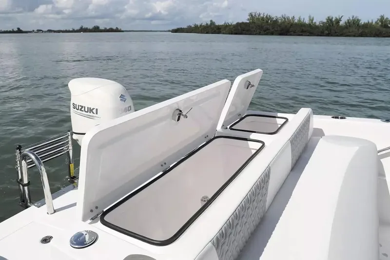 Slide: The Image of 2026 Twin Vee 240 GFX DC boat with Suzuki engine on calm water. - 5