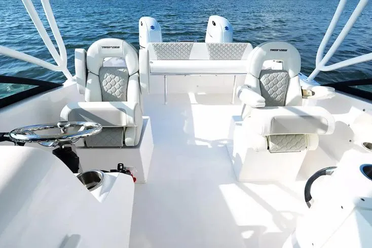 Slide: The Image of Manufacturer Provided Image: 2026 Twin Vee 240 GFX DC boat interior with luxurious seating on open water. - 7