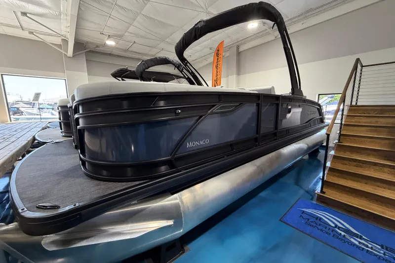 The Image of 2026 Godfrey Monaco 255 MTF pontoon boat displayed indoors, showcasing sleek design. - 0