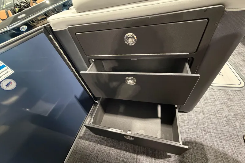 Slide: The Image of Open storage drawers on a 2026 Godfrey Monaco 255 MTF boat interior. - 13