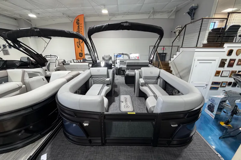 Slide: The Image of 2026 Godfrey Monaco 255 MTF pontoon boat with luxurious seating in showroom. - 2