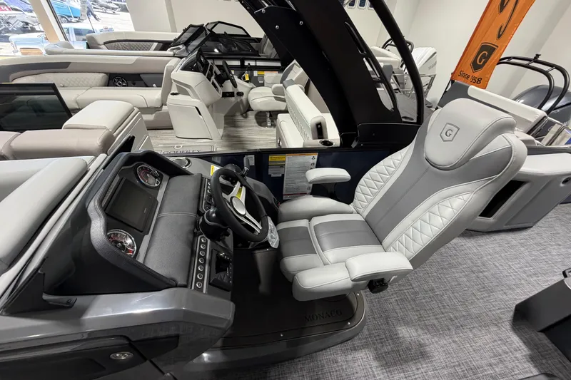 Slide: The Image of Luxurious interior of 2026 Godfrey Monaco 255 MTF pontoon boat with plush seating and modern dashboard. - 4