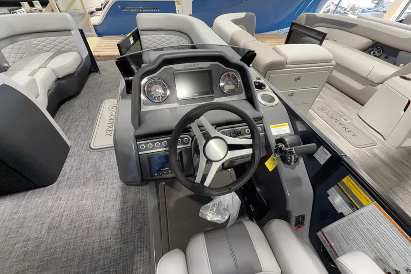 Slide: The Image of Interior view of 2026 Godfrey Monaco 255 MTF boat, featuring modern steering console and seating. - 5