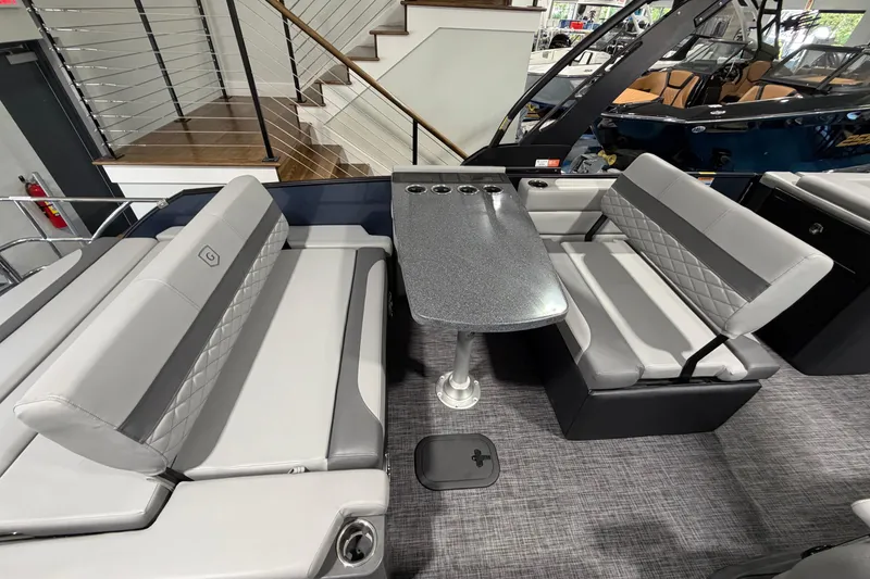 Slide: The Image of Luxurious seating area on 2026 Godfrey Monaco 255 MTF pontoon boat with sleek table design. - 7