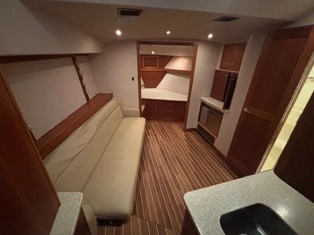 Slide: The Image of Interior of 2007 Albemarle 36 Express Fisherman with wood flooring and leather sofa. - 6