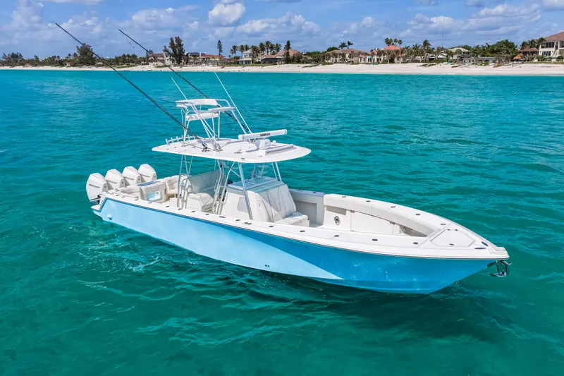 The Image of 2021 SeaVee 390B boat on turquoise water, featuring multiple outboard engines. - 1