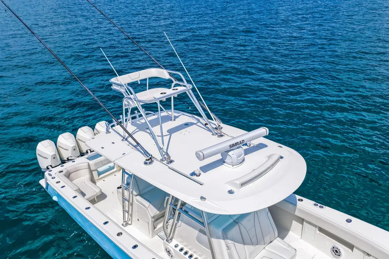 Slide: The Image of 2021 SeaVee 390B boat with multiple outboard engines on clear blue water. - 12