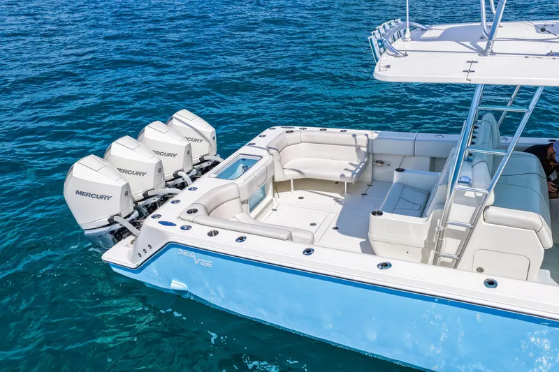 Slide: The Image of 2021 SeaVee 390B boat with four Mercury engines on clear blue water. - 13