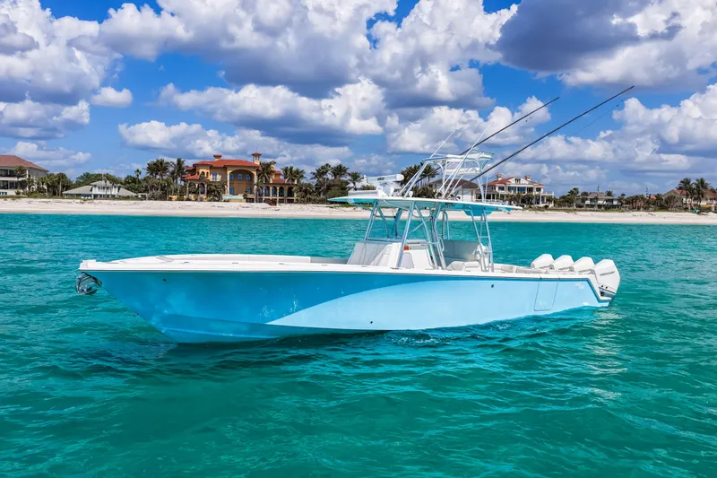 Slide: The Image of 2021 SeaVee 390B boat on turquoise water near a sandy beach under a cloudy sky. - 16