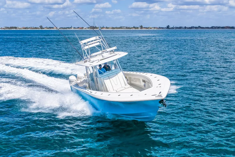 Slide: The Image of 2021 SeaVee 390B boat cruising on open blue ocean under clear skies. - 19