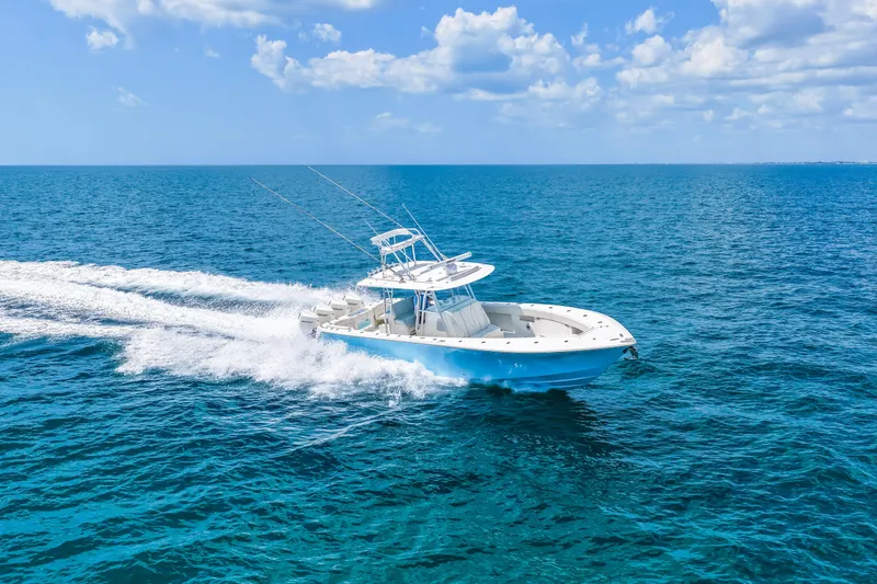 Slide: The Image of 2021 SeaVee 390B boat cruising on open ocean under clear blue sky. - 21