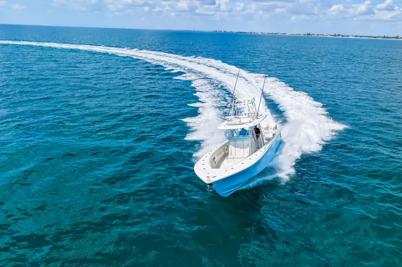 Slide: The Image of 2021 SeaVee 390B boat cruising on clear blue ocean waters. - 22