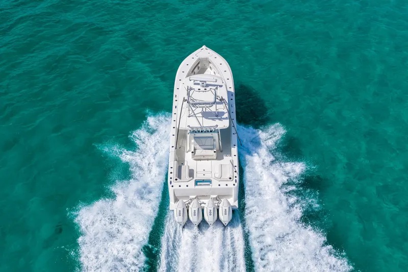 Slide: The Image of 2021 SeaVee 390B boat cruising on clear turquoise water, aerial view. - 24