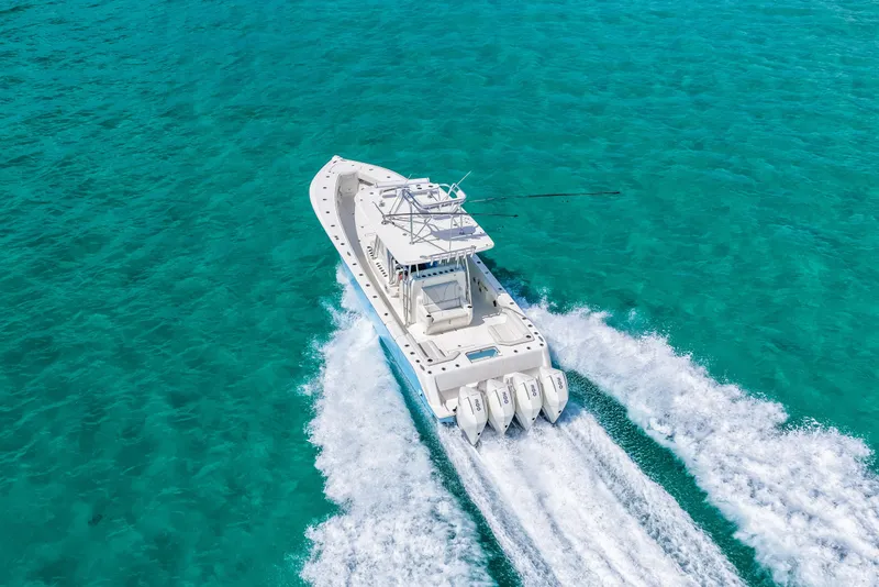 Slide: The Image of 2021 SeaVee 390B boat cruising on clear turquoise waters. - 25