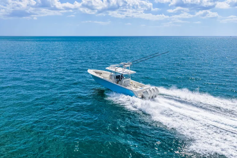 Slide: The Image of 2021 SeaVee 390B boat cruising on open ocean under blue sky. - 28