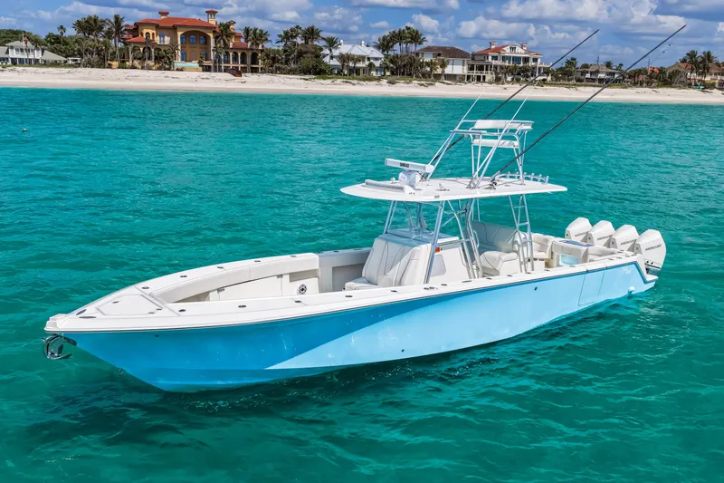 Slide: The Image of 2021 SeaVee 390B boat on turquoise water near a sandy beach and luxury homes. - 3