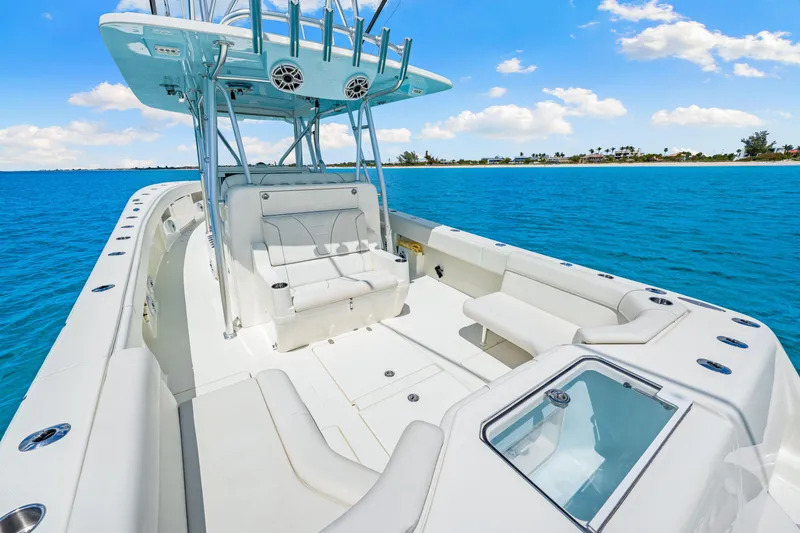 Slide: The Image of 2021 SeaVee 390B boat with spacious deck, white seating, and ocean backdrop. - 31