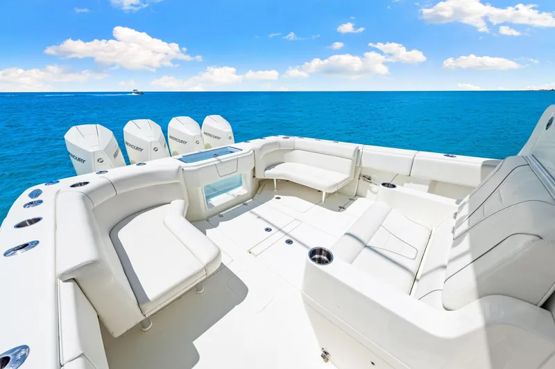 Slide: The Image of 2021 SeaVee 390B boat with spacious seating and multiple outboard engines on open water. - 33