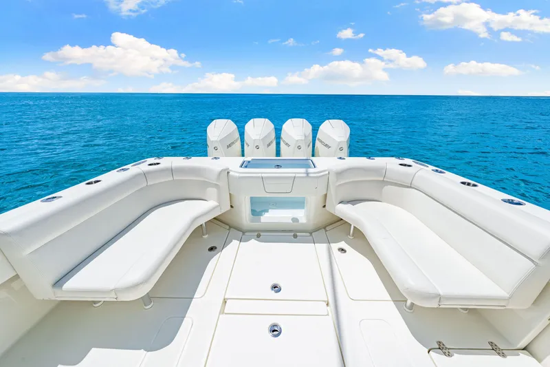 Slide: The Image of 2021 SeaVee 390B boat with white seating, ocean view, and multiple outboard engines. - 34