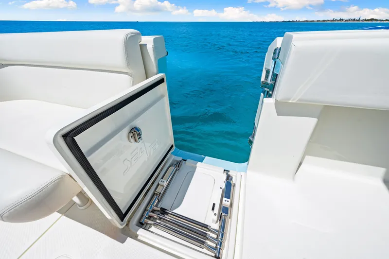Slide: The Image of 2021 SeaVee 390B boat with open hatch and ladder, overlooking clear blue ocean. - 35