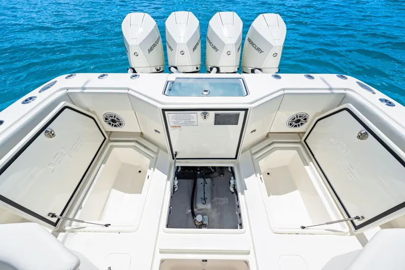 Slide: The Image of 2021 SeaVee 390B boat deck with storage compartments and Mercury engines. - 36