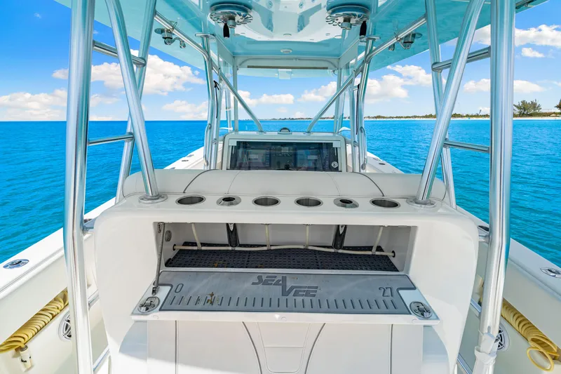Slide: The Image of 2021 SeaVee 390B boat interior with rod holders, ocean view, and clear blue skies. - 42